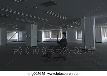 Stock Photography - Japanese businessman in empty office. Fotosearch