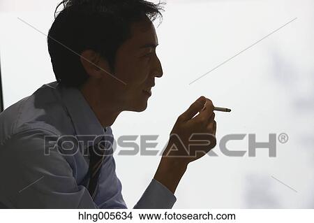 Japanese businessman in smoking room View Large Photo Image Picture - Japanese businessman in smoking room. Fotosearch