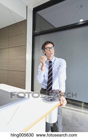 Japanese businessman in smoking room View Large Photo Image Stock Image - Japanese businessman in smoking room. Fotosearch