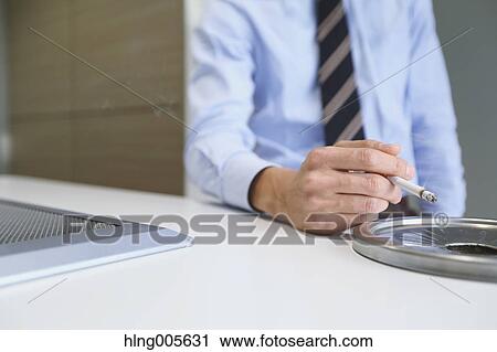 Japanese businessman in smoking room View Large Photo Image Stock Image - Japanese businessman in smoking room. Fotosearch