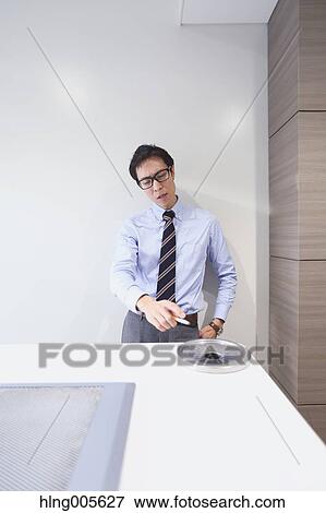 Stock Photo - Japanese businessman in smoking room. Fotosearch