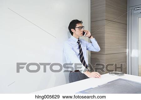 Stock Photo - Japanese businessman in smoking room. Fotosearch