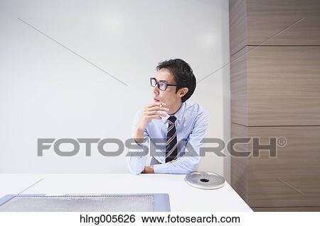 Japanese businessman in smoking room View Large Photo Image Stock Photograph - Japanese businessman in smoking room. Fotosearch