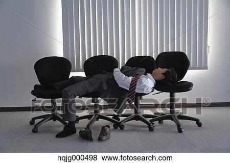 Japanese businessman sleeping on chairs View Large Photo Image Stock Photo - Japanese businessman sleeping on chairs. Fotosearch