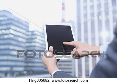 Japanese businessman with tablet View Large Photo Image Stock Image - Japanese businessman with tablet. Fotosearch