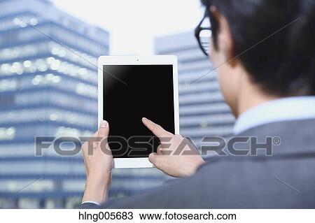 Japanese businessman with tablet View Large Photo Image Stock Image - Japanese businessman with tablet. Fotosearch