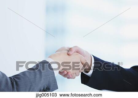 Stock Image - Japanese businesspeople in a modern office. Fotosearch