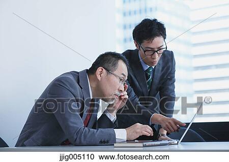 Japanese businesspeople in a modern office View Large Photo Image Stock Image - Japanese businesspeople in a modern office. Fotosearch