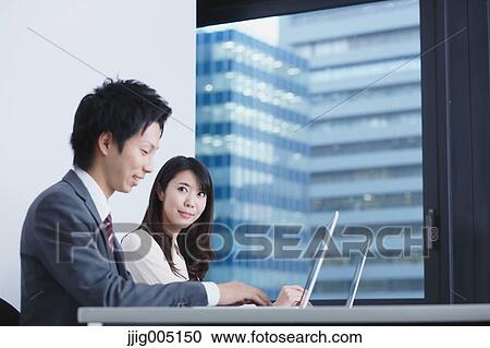 Japanese businesspeople in a modern office View Large Photo Image Stock Image - Japanese businesspeople in a modern office. Fotosearch
