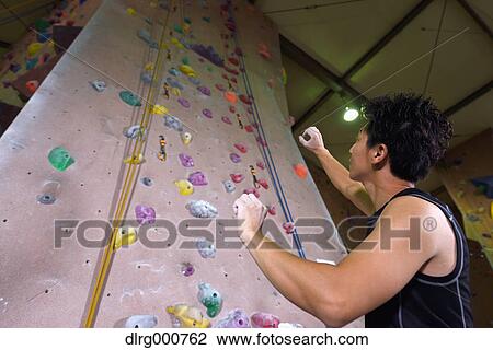 Japanese climbing athlete getting ready to climb gym wall View Large Photo Image Stock Image - Japanese climbing athlete getting ready to climb gym wall. Fotosearch