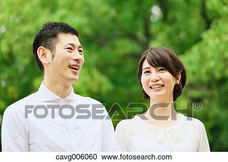Japanese couple in a city park View Large Photo Image Stock Image - Japanese couple in a city park. Fotosearch