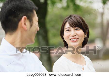 Japanese couple in a city park View Large Photo Image Stock Image - Japanese couple in a city park. Fotosearch