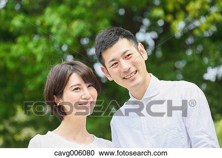 Japanese couple in a city park View Large Photo Image Stock Image - Japanese couple in a city park. Fotosearch