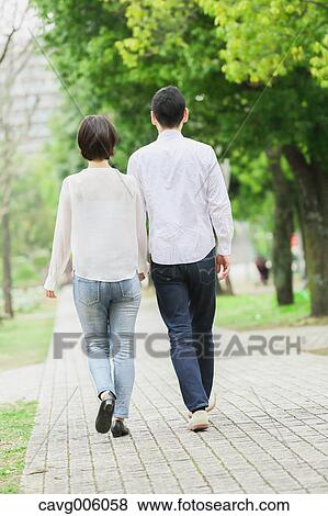 Stock Photo - Japanese couple in a city park. Fotosearch