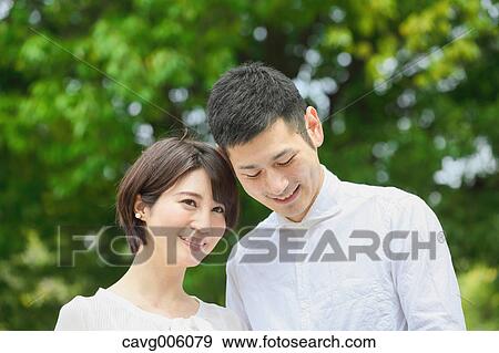 Japanese couple in a city park View Large Photo Image Stock Photo - Japanese couple in a city park. Fotosearch