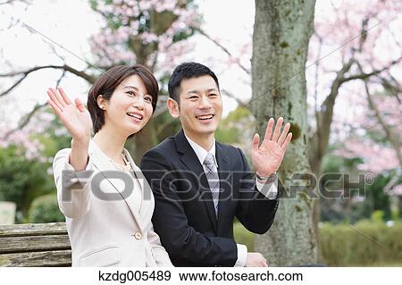 Japanese couple with cherry blossoms in a city park View Large Photo Image Stock Photo - Japanese couple with cherry blossoms in a city park. Fotosearch