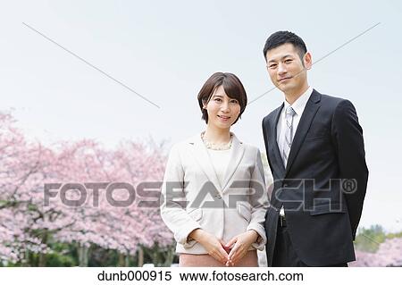 Japanese couple with cherry blossoms in a city park View Large Photo Image Stock Photography - Japanese couple with cherry blossoms in a city park. Fotosearch