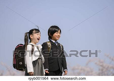 Japanese elementary school students and cherry blossoms View Large Photo Image Picture - Japanese elementary school students and cherry blossoms. Fotosearch