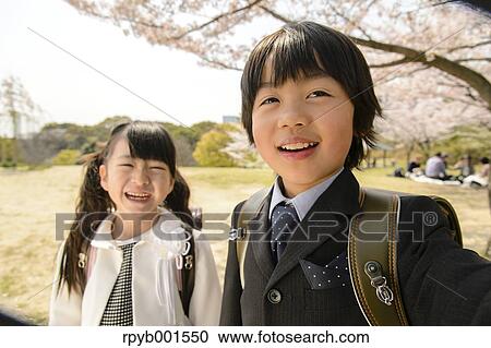 Japanese elementary school students and cherry blossoms View Large Photo Image Stock Image - Japanese elementary school students and cherry blossoms. Fotosearch