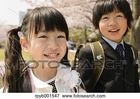 Japanese elementary school students and cherry blossoms View Large Photo Image Stock Photo - Japanese elementary school students and cherry blossoms. Fotosearch