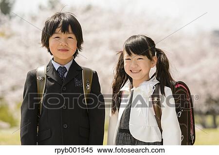 Stock Photography - Japanese elementary school students and cherry blossoms. Fotosearch