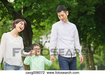 Stock Image - Japanese family in a city park. Fotosearch