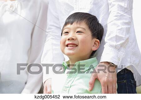 Stock Image - Japanese family in a city park. Fotosearch