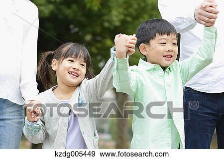 Stock Photo - Japanese family in a city park. Fotosearch