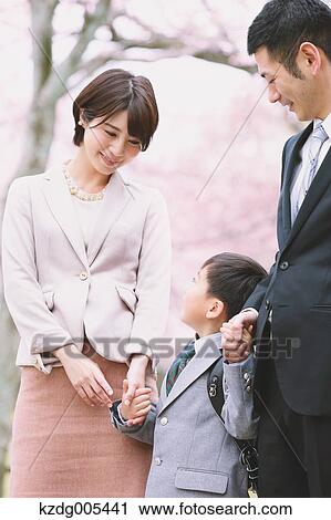 Japanese family with cherry blossoms in a city park View Large Photo Image Stock Image - Japanese family with cherry blossoms in a city park. Fotosearch