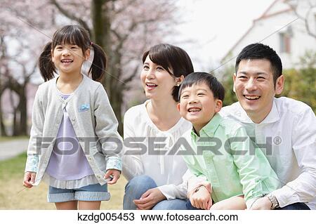 Japanese family with cherry blossoms in a city park View Large Photo Image Stock Image - Japanese family with cherry blossoms in a city park. Fotosearch
