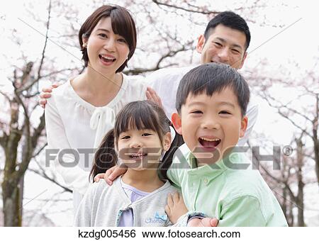 Japanese family with cherry blossoms in a city park View Large Photo Image Stock Photograph - Japanese family with cherry blossoms in a city park. Fotosearch