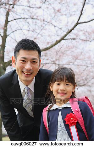 Japanese father and daughter with cherry blossoms in a city park View Large Photo Image Stock Photo - Japanese father and daughter with cherry blossoms in a city park. Fotosearch