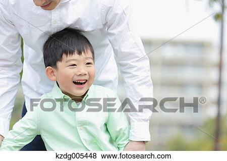 Japanese father and son in a city park View Large Photo Image Stock Photo - Japanese father and son in a city park. Fotosearch