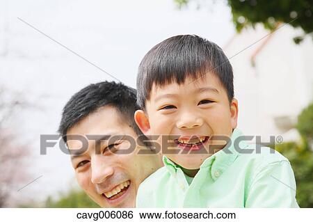 Japanese father and son in a city park View Large Photo Image Stock Photograph - Japanese father and son in a city park. Fotosearch