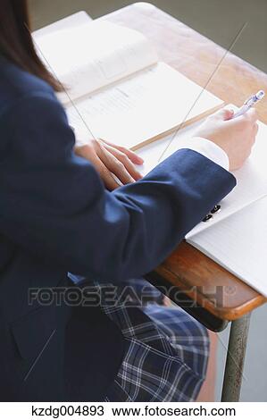 Stock Image - Japanese high-school student during a lesson. Fotosearch