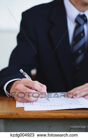 Stock Image - Japanese high-school student during a lesson. Fotosearch