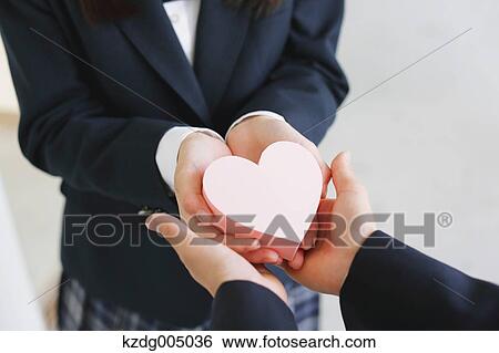 Stock Photograph - Japanese high-school student giving present. Fotosearch