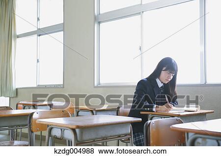 Stock Photo - Japanese high-school student in empty classroom. Fotosearch