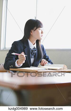 Stock Photo - Japanese high-school student in empty classroom. Fotosearch