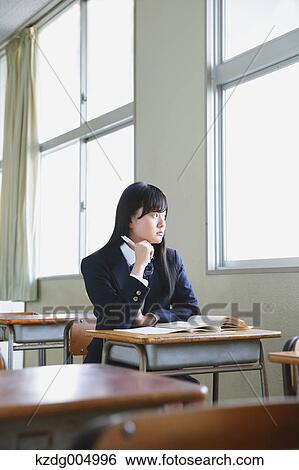Stock Photograph - Japanese high-school student in empty classroom. Fotosearch