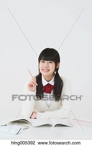 Stock Image - Japanese High-school student in uniform against white background. Fotosearch