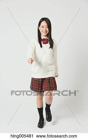 Stock Image - Japanese High-school student in uniform against white background. Fotosearch