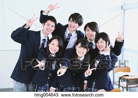 Stock Image - Japanese high-school student taking group shot in classroom. Fotosearch