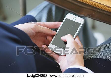 Japanese high-school student using smartphone during a lesson View Large Photo Image Stock Photo - Japanese high-school student using smartphone during a lesson. Fotosearch