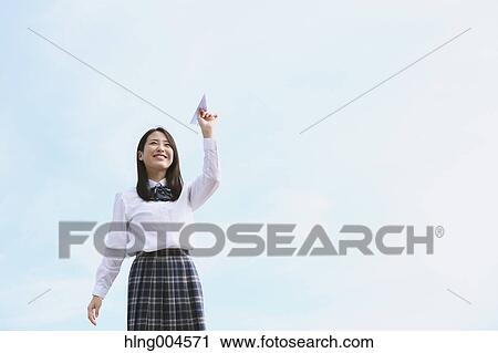 Japanese high-school student with paper plane View Large Photo Image Stock Image - Japanese high-school student with paper plane. Fotosearch