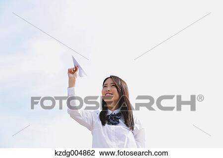 Japanese high-school student with paper plane View Large Photo Image Stock Image - Japanese high-school student with paper plane. Fotosearch