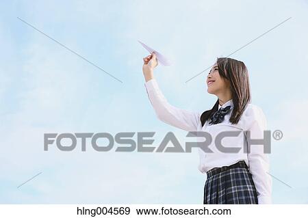 Stock Photo - Japanese high-school student with paper plane. Fotosearch