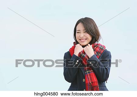 Stock Image - Japanese high-school student with scarf against blue sky. Fotosearch