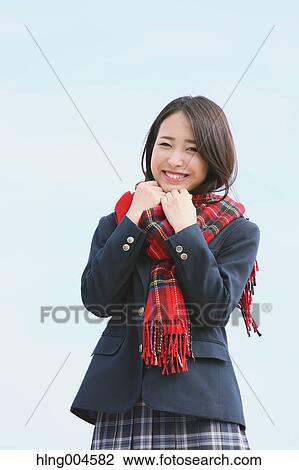 Stock Image - Japanese high-school student with scarf against blue sky. Fotosearch