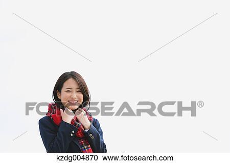 Stock Image - Japanese high-school student with scarf against blue sky. Fotosearch